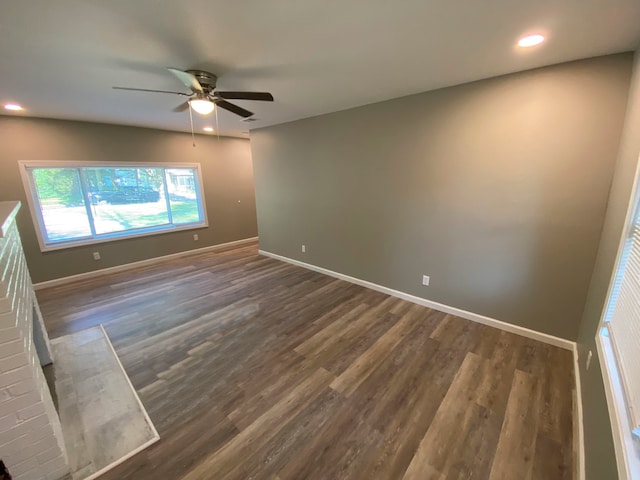 spare room with ceiling fan and dark hardwood / wood-style flooring