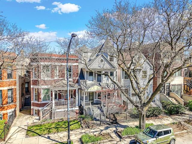 view of front of property with stairs and covered porch