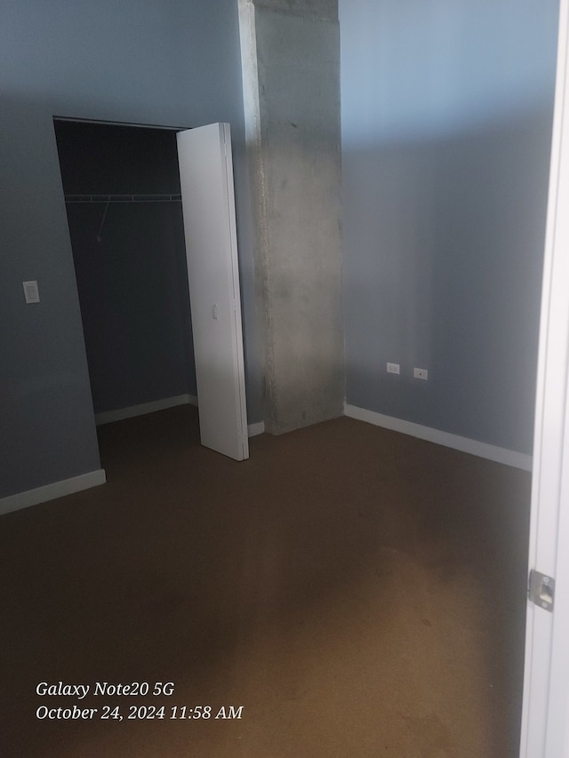 unfurnished bedroom with a closet and carpet flooring