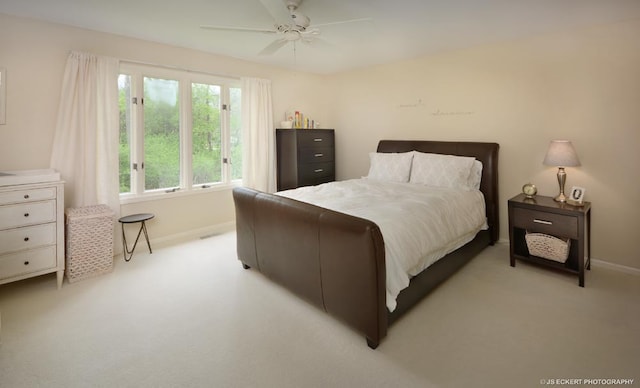 bedroom with ceiling fan and light colored carpet