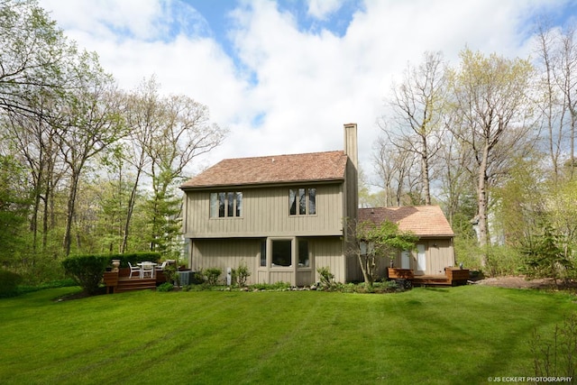 back of property with a yard and central AC unit