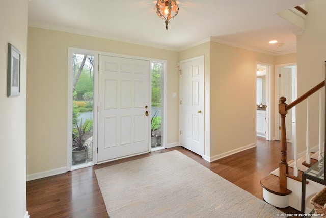 foyer with crown molding and dark wood-type flooring