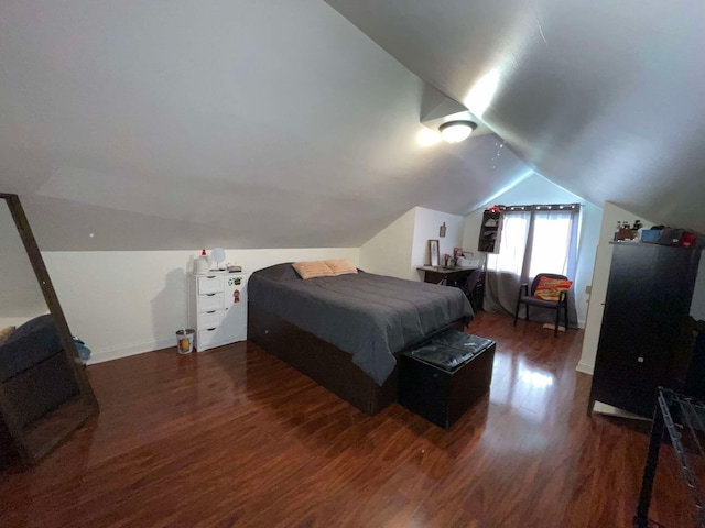 bedroom featuring vaulted ceiling and dark hardwood / wood-style floors