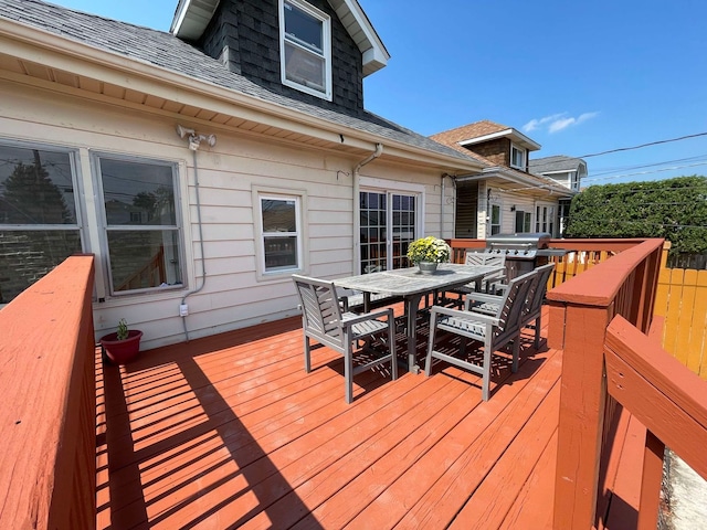 wooden terrace featuring a grill