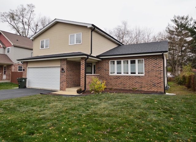 view of front of home with a front lawn and a garage