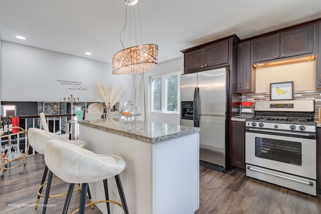 kitchen featuring gas stove, a kitchen island, dark wood-type flooring, and stainless steel refrigerator with ice dispenser