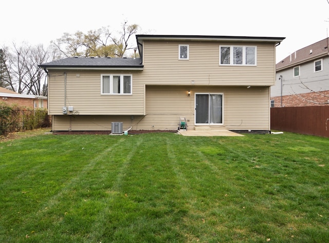 back of house with a lawn, a patio, and central AC