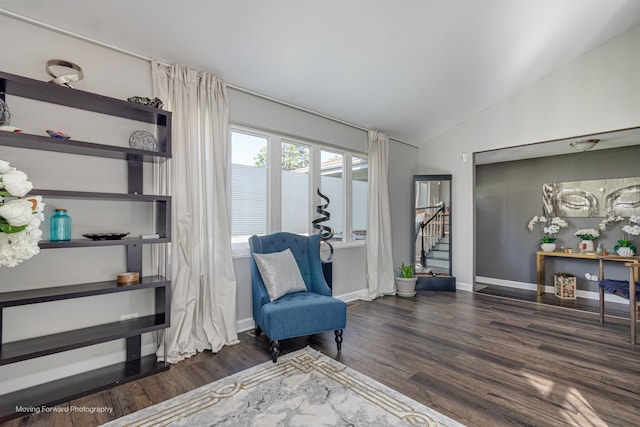 living area with dark hardwood / wood-style floors and vaulted ceiling