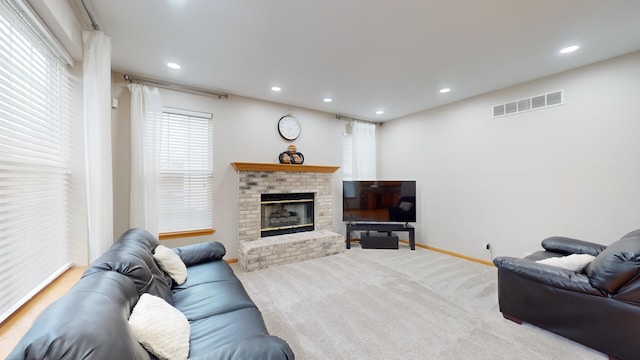 carpeted living room featuring a fireplace