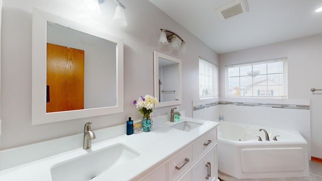 bathroom with a tub to relax in and vanity