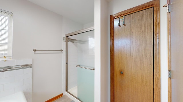 bathroom with a shower with door