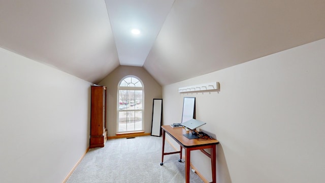 doorway with light carpet and vaulted ceiling