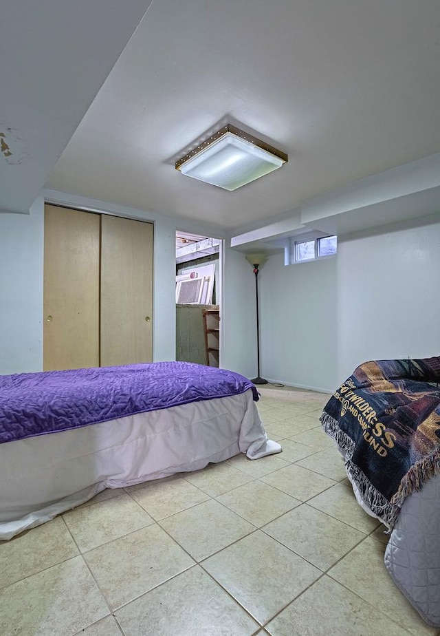 bedroom featuring light tile patterned floors and a closet