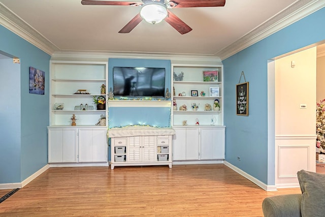 living room featuring built in features, light hardwood / wood-style floors, and ornamental molding