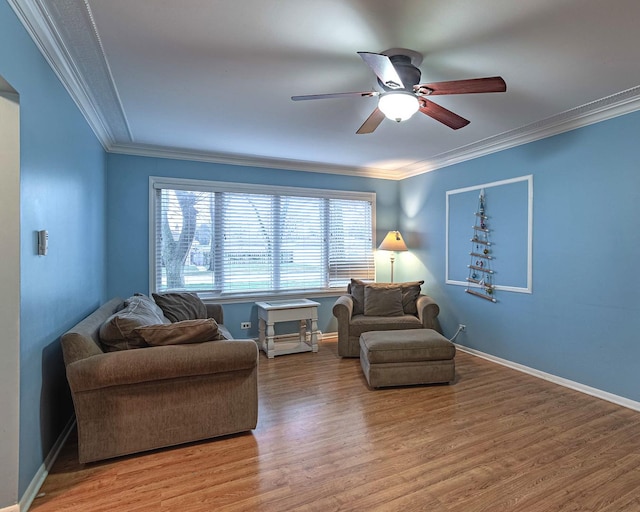 sitting room featuring ceiling fan, a healthy amount of sunlight, and ornamental molding