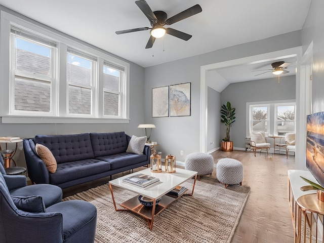 living room with lofted ceiling, ceiling fan, and wood-type flooring