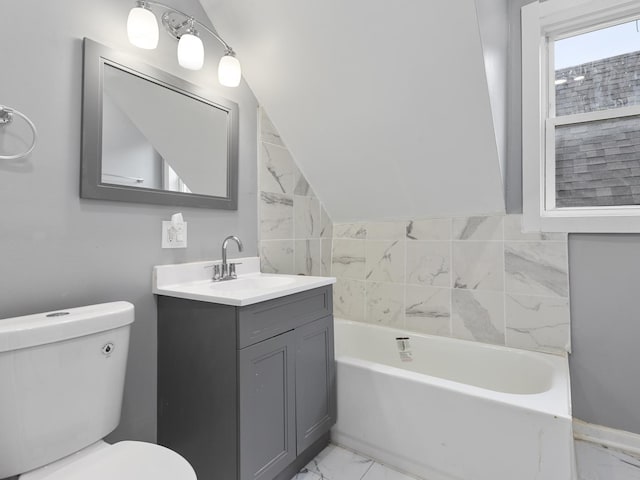 bathroom featuring vanity, toilet, and vaulted ceiling