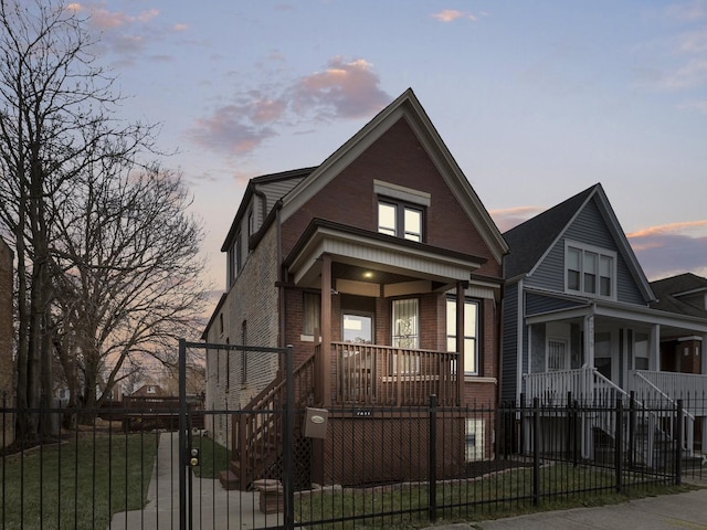 view of front of property featuring a lawn and covered porch