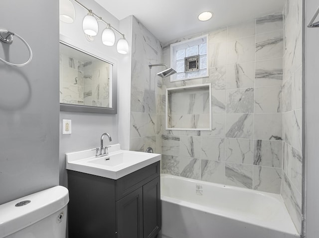 full bathroom featuring vanity, toilet, and tiled shower / bath