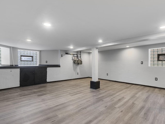 basement with light hardwood / wood-style flooring