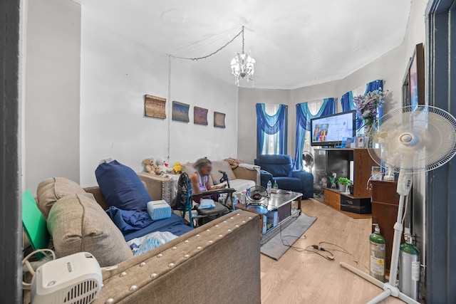 living room with a notable chandelier and hardwood / wood-style floors