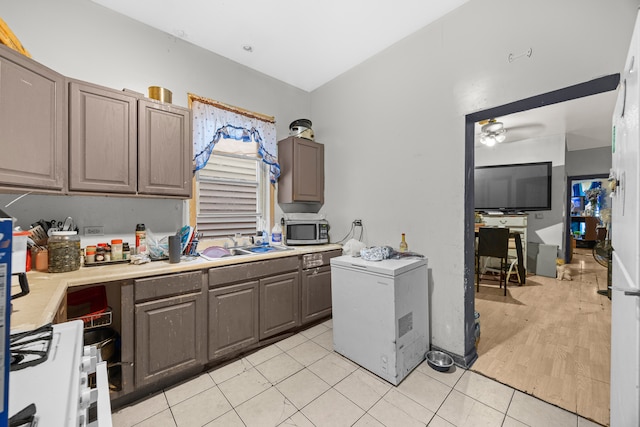 kitchen with ceiling fan, sink, light hardwood / wood-style floors, and fridge