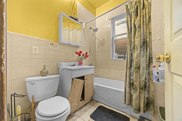 full bathroom with shower / bath combination with curtain, tile walls, toilet, vanity, and tile patterned flooring