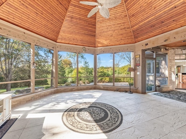 unfurnished sunroom with ceiling fan and wood ceiling