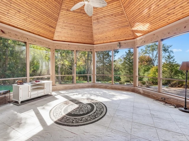 unfurnished sunroom with wood ceiling and ceiling fan