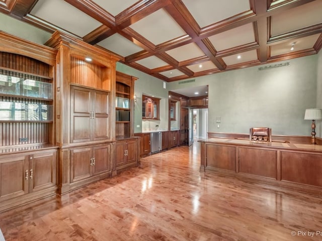 interior space with light hardwood / wood-style flooring, ornamental molding, dishwasher, beamed ceiling, and coffered ceiling