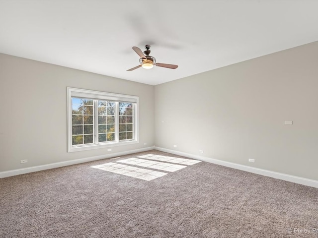 empty room featuring carpet floors and ceiling fan