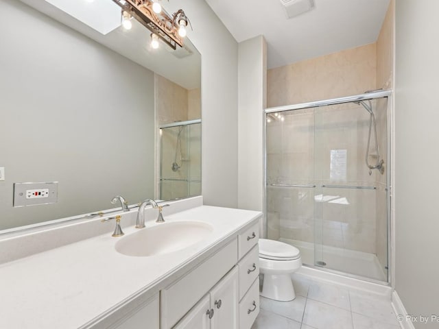 bathroom featuring toilet, a skylight, vanity, an enclosed shower, and tile patterned floors