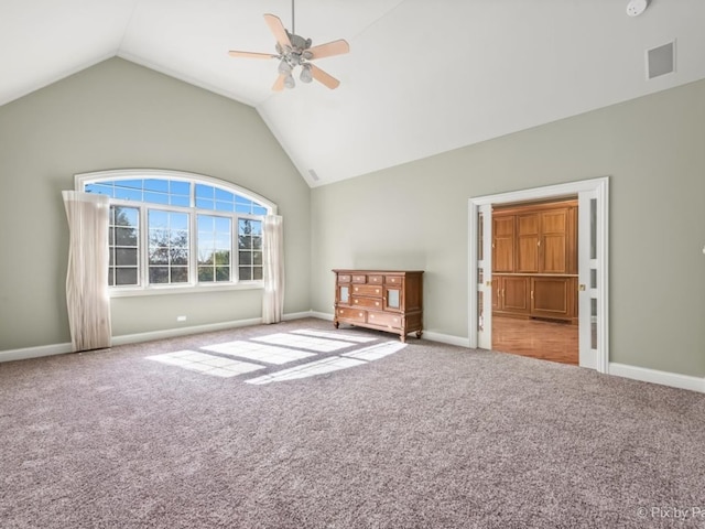 interior space with lofted ceiling, carpet, and ceiling fan