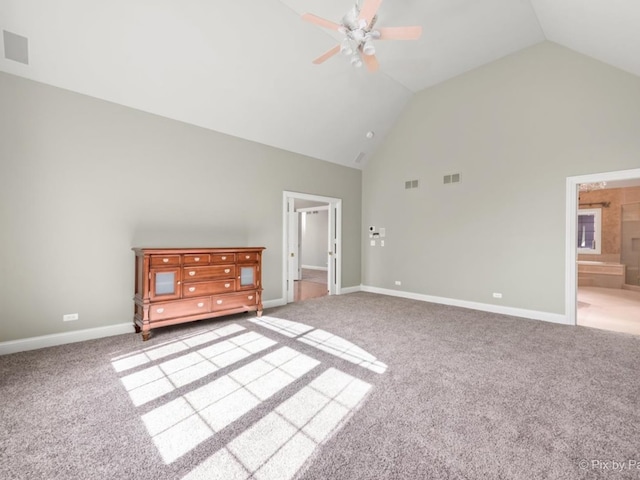 interior space featuring carpet floors, high vaulted ceiling, and connected bathroom