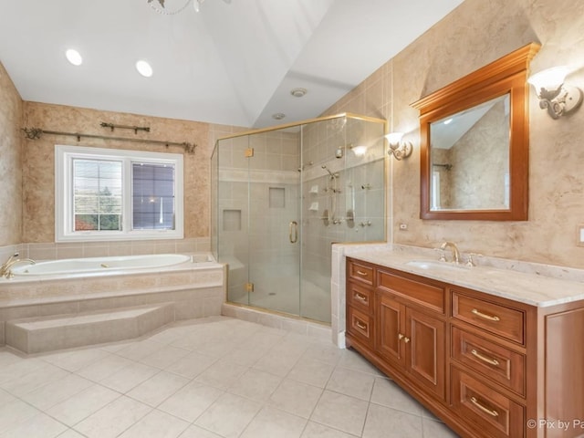 bathroom featuring independent shower and bath, tile walls, vaulted ceiling, vanity, and tile patterned flooring