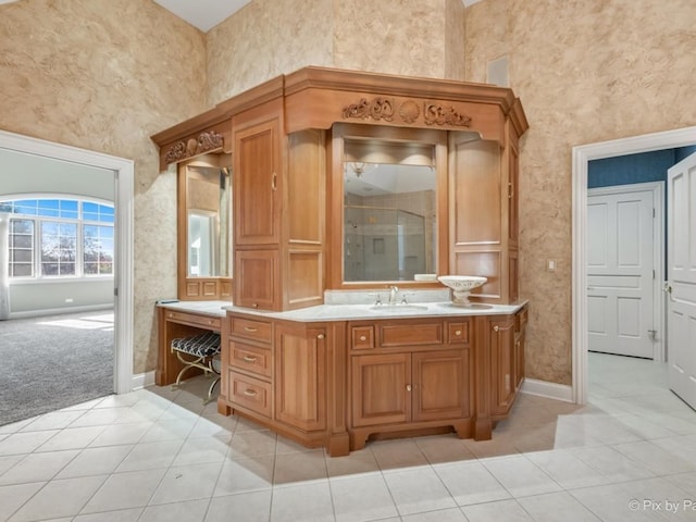 bathroom featuring vanity, tile patterned floors, a towering ceiling, and an enclosed shower