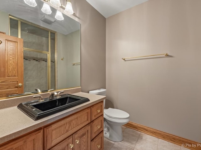 bathroom with a shower with door, toilet, tile patterned floors, and vanity