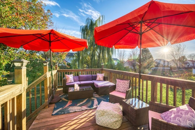 wooden terrace with an outdoor living space