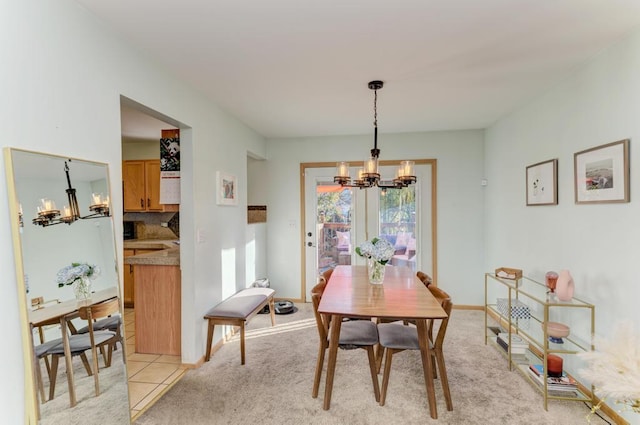 dining space featuring a chandelier and light carpet