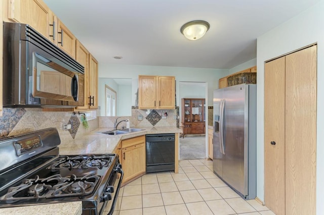 kitchen with sink, black appliances, tasteful backsplash, light brown cabinets, and light tile patterned floors