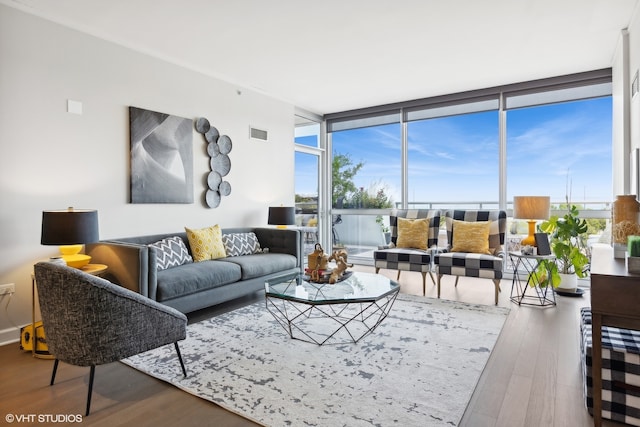 living room featuring wood-type flooring and floor to ceiling windows