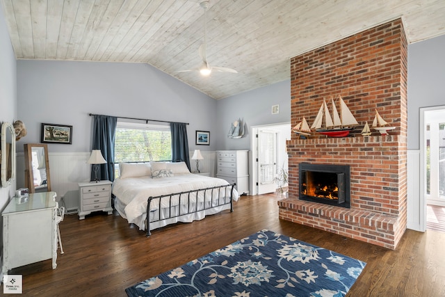 bedroom with wood ceiling, dark hardwood / wood-style flooring, and a fireplace