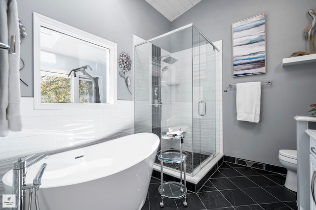 full bathroom with vanity, toilet, tile patterned floors, and separate shower and tub