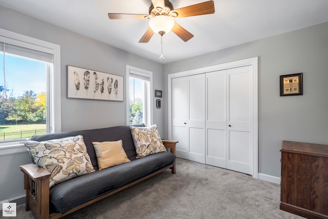 living room with ceiling fan and light colored carpet