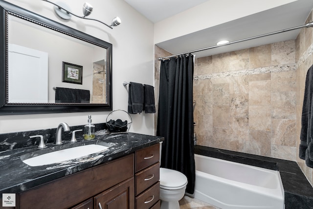 full bathroom with vanity, shower / tub combo with curtain, and toilet