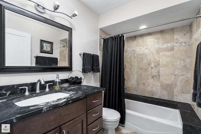 bathroom featuring toilet, shower / tub combo, and vanity