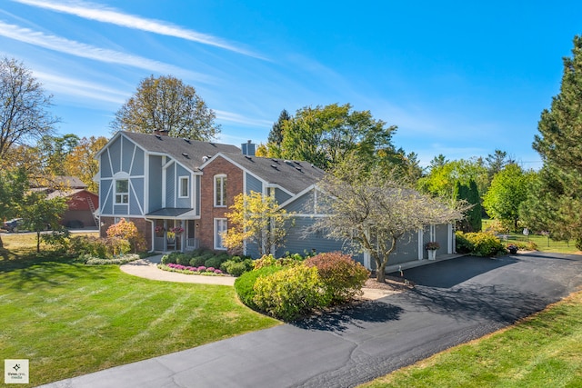 view of front of house with a front yard and a garage