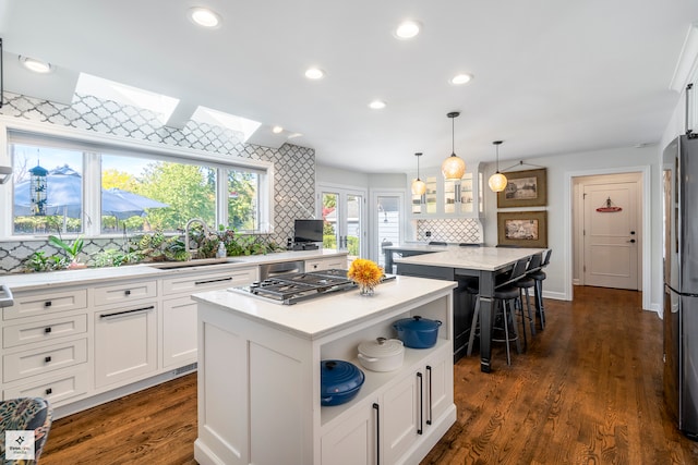 kitchen featuring tasteful backsplash, a center island, and dark wood-type flooring