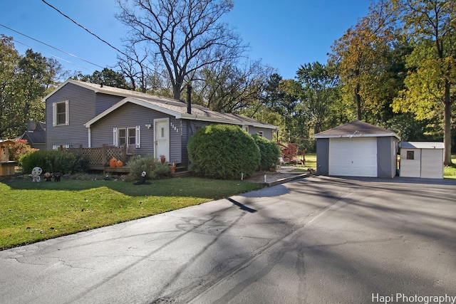 view of home's exterior featuring a garage, a yard, and an outdoor structure