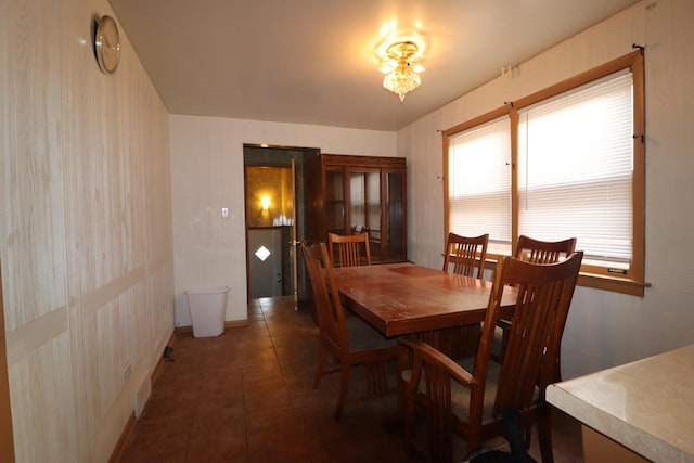 dining area with dark tile patterned flooring